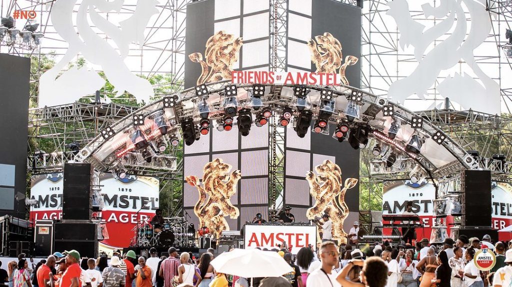 Friends of Amstel logo with a crowd of people enjoying a music festival atmosphere.